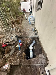 Plumber fixing water leaking pipe